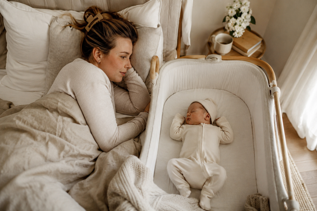 Newborn baby sleeping in soft footie pajamas during the first few months