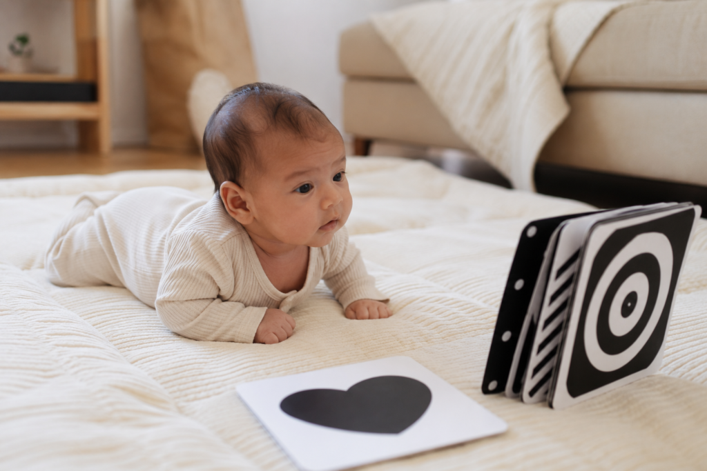 Newborn on soft play mat during a simple wake window activity at home.