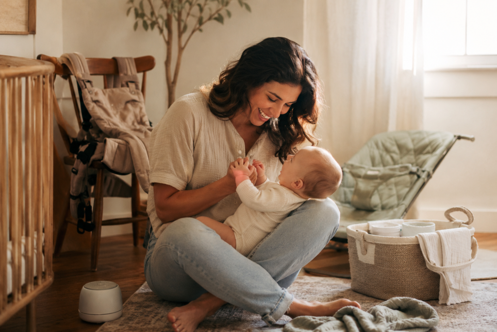 Mom playing with her baby in a cozy minimalist nursery with everyday newborn essentials.
